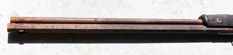 Closeup of Barrel of antique rifle that rusted in a basement for a century or more..